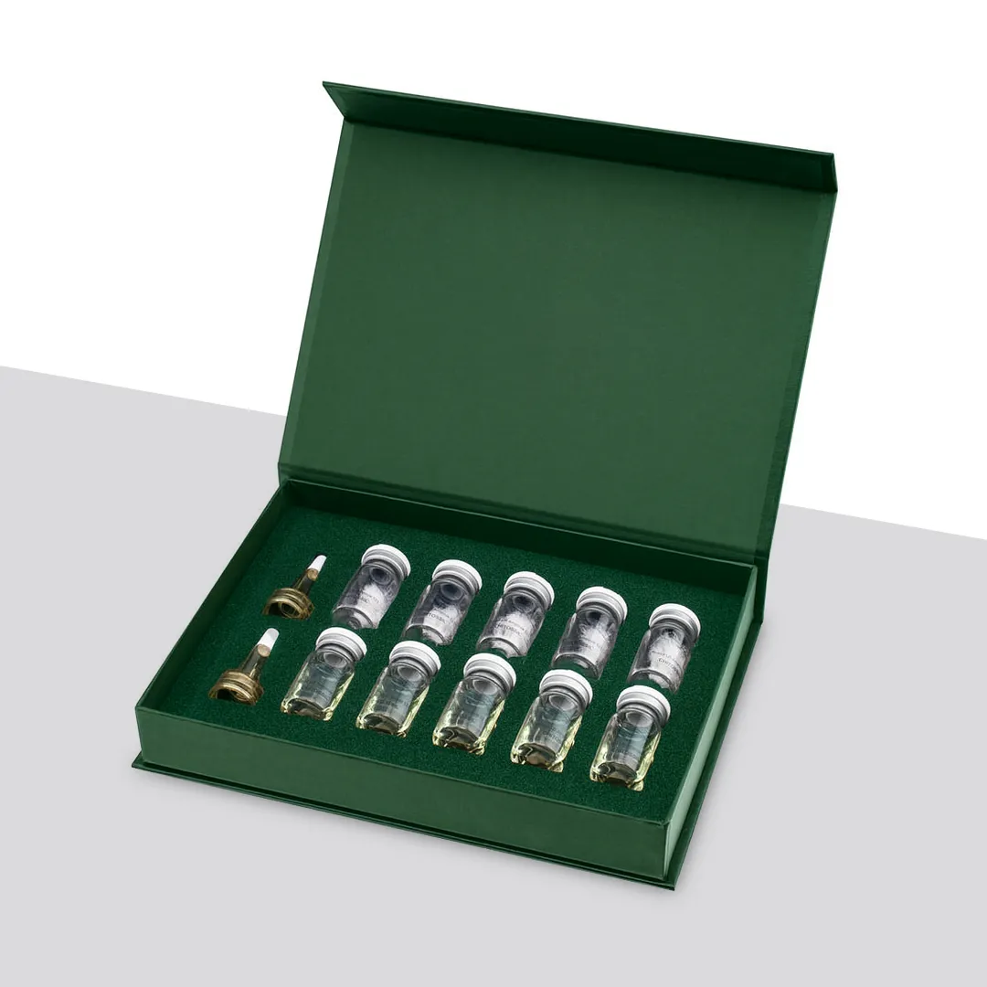 Dark green magnetic box opened flat with twelve small vials in a row-and-column foam layout