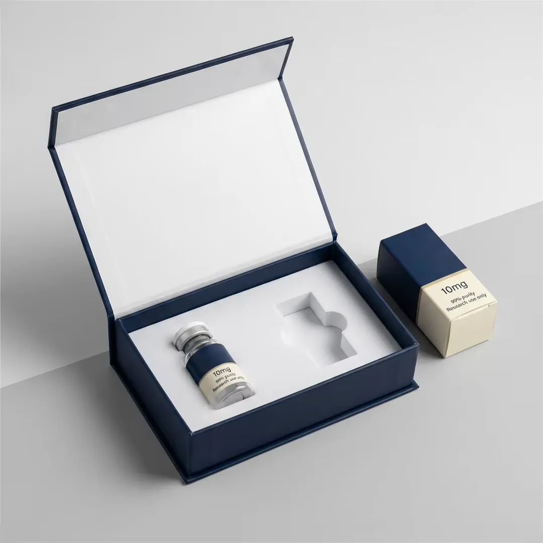 Deep navy rigid box open to show a single vial in a white moulded cavity beside a small cream carton