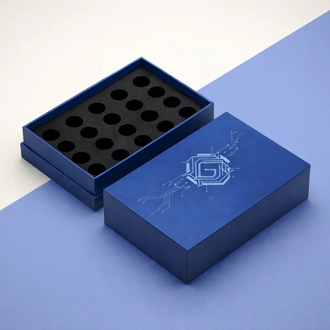 Navy two-piece box with the lid removed, showing a black foam insert with twenty round cavities
